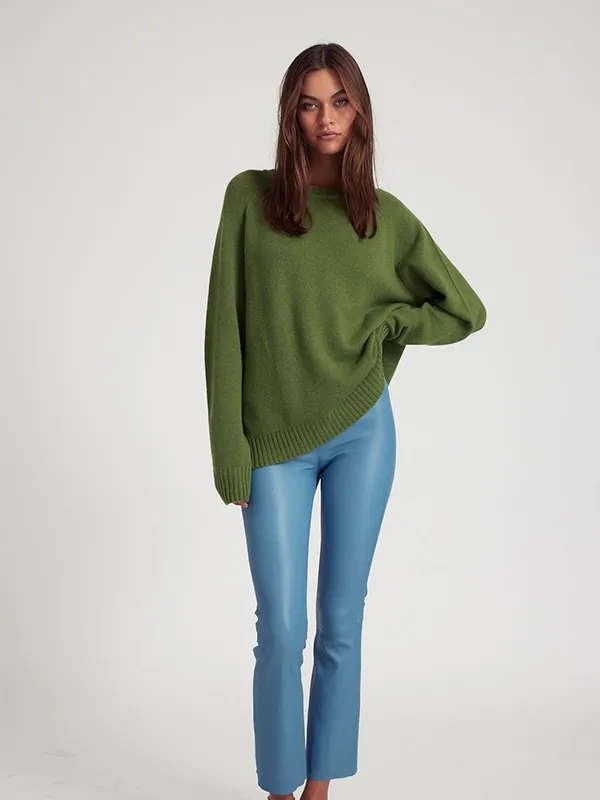 Solid color knit sweater with dark green crew neck